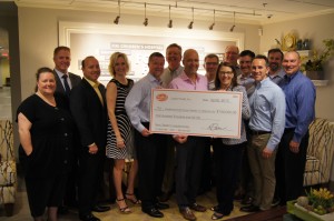 A group of employees from Lopez Foods, Inc. presenting a giant check of $100,000 to the Ronald McDonald House Charities of Oklahoma CIty President Susan Adams