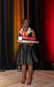 Tonjua Whetsone holding big red shoe award