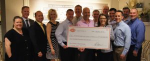 A group of employees from Lopez Foods, Inc. presenting a giant check of $100,000 to the Ronald McDonald House Charities of Oklahoma CIty President Susan Adams